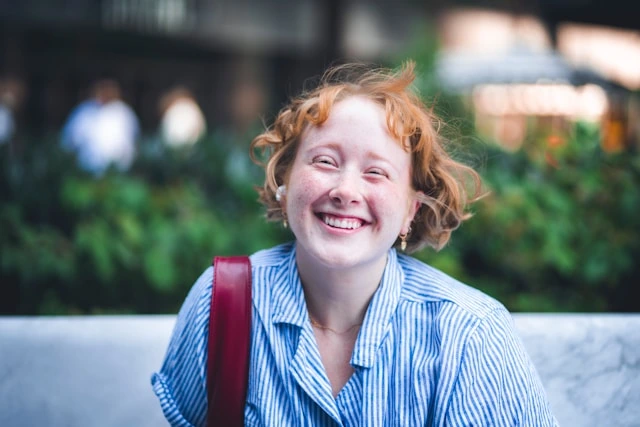 Person smiling, representing the joy of discovering patterns and self-knowledge through journaling
